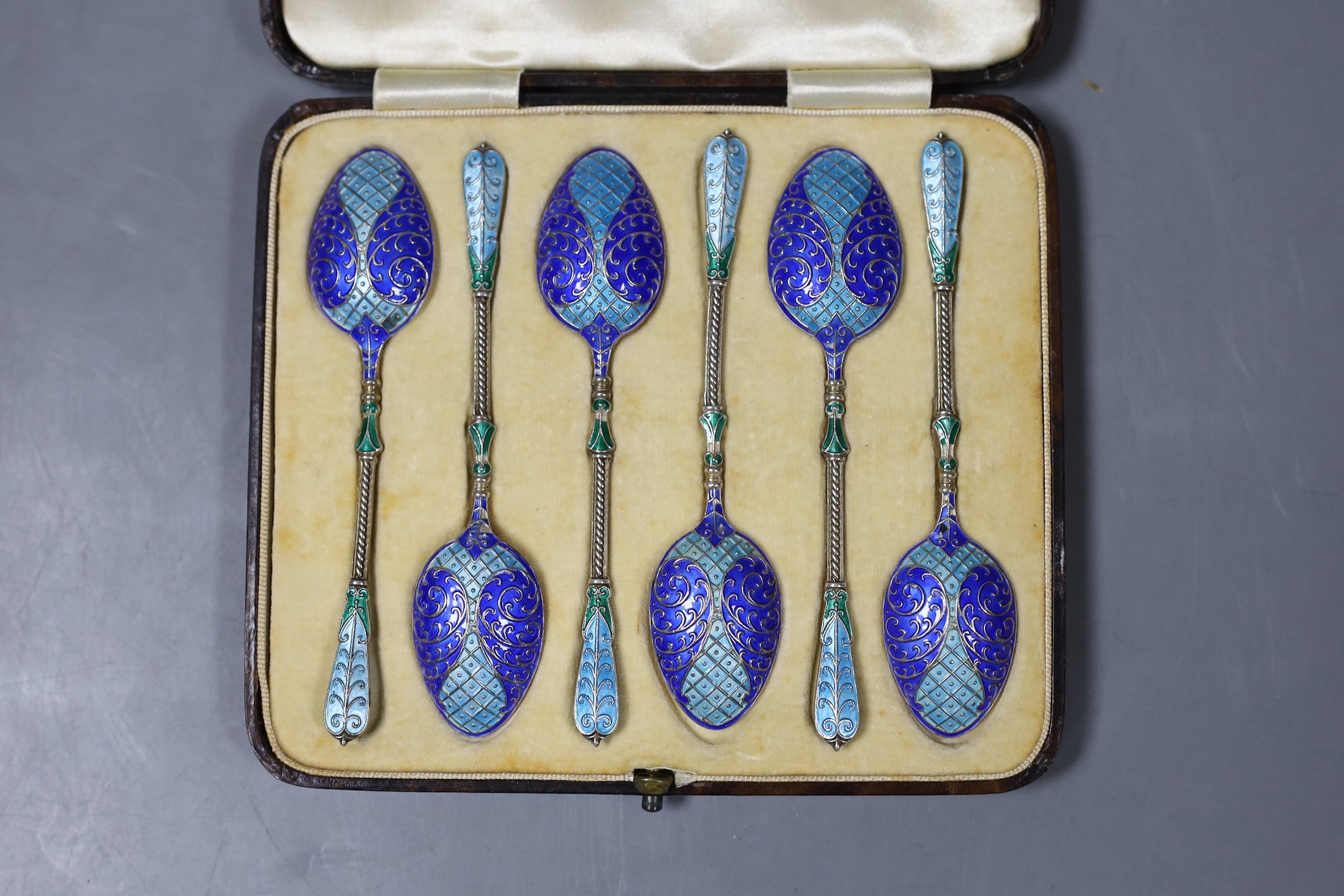 A cased set of six George V silver and three colour enamel teaspoons, Turner & Simpson, Birmingham, 1913, 10.2cm.